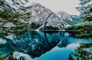 A serene lake reflecting the towering peaks of the Rocky Mountains
