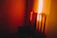 A glowing orange chair bathed in soft, ethereal light against a shadowy background.