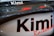 A close-up view of a vehicle part with the name 'Kimi Raikkonen' prominently displayed. The surface is sleek and shiny, with reflections indicating a polished finish. The text is printed in bold black letters with a red underline.