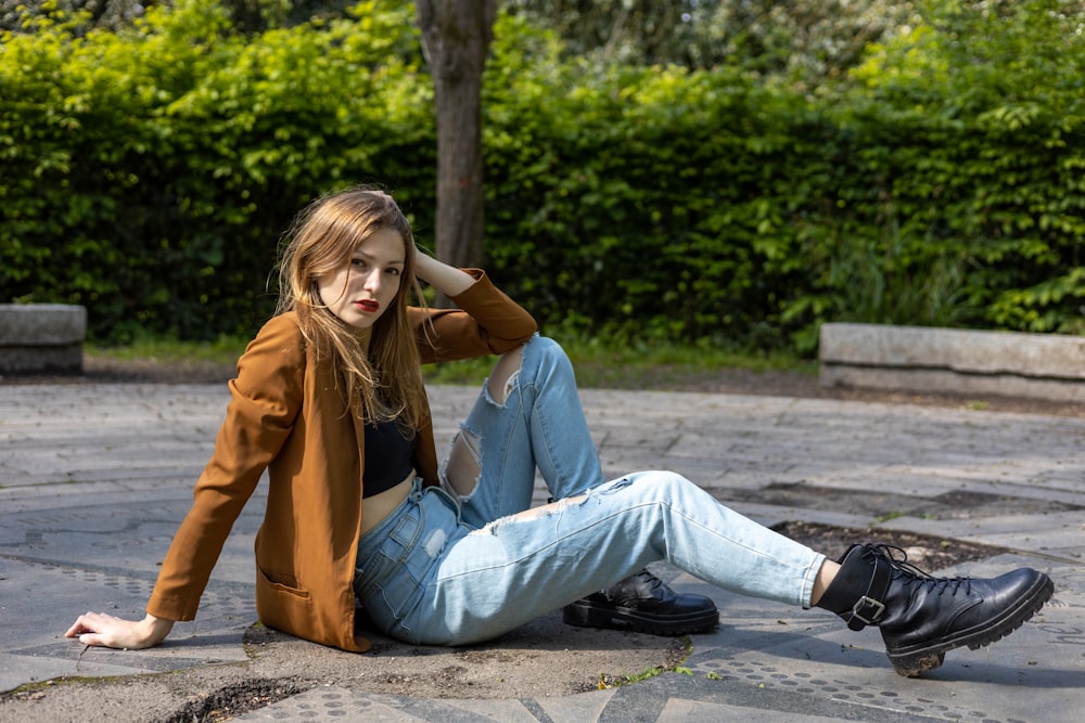 a woman sitting on the ground with her legs crossed