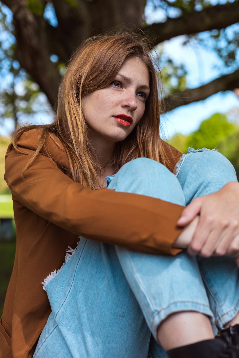 a woman sitting on the ground with her legs crossed