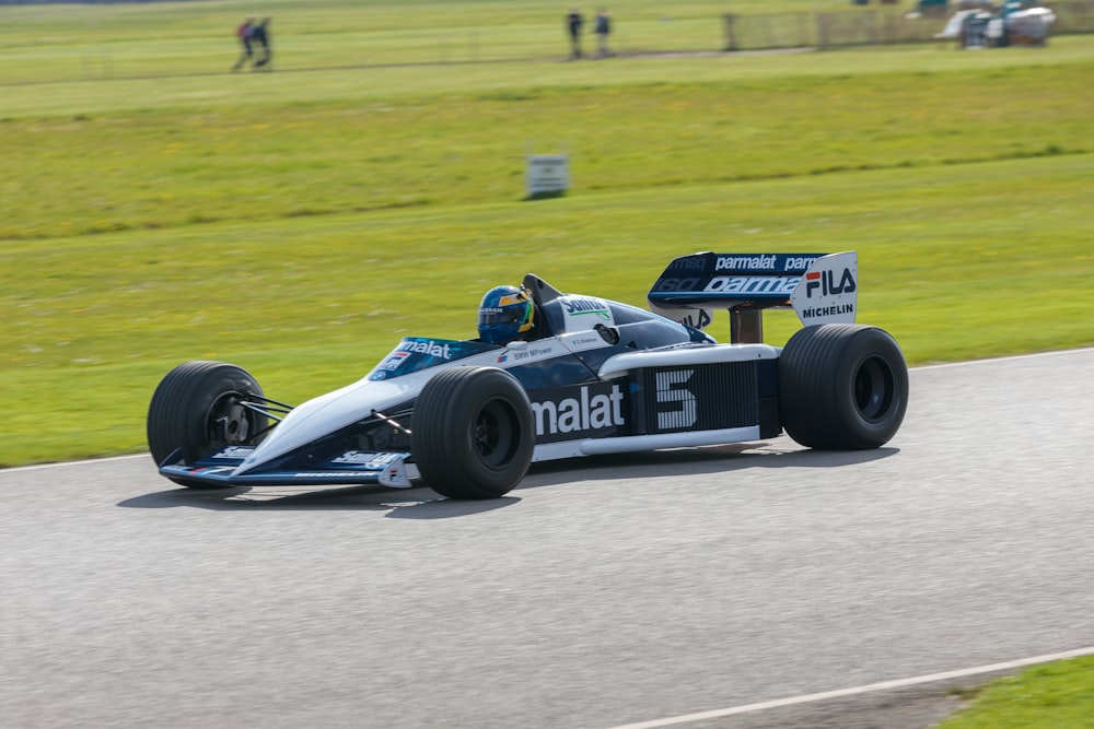 a man driving a race car on a track