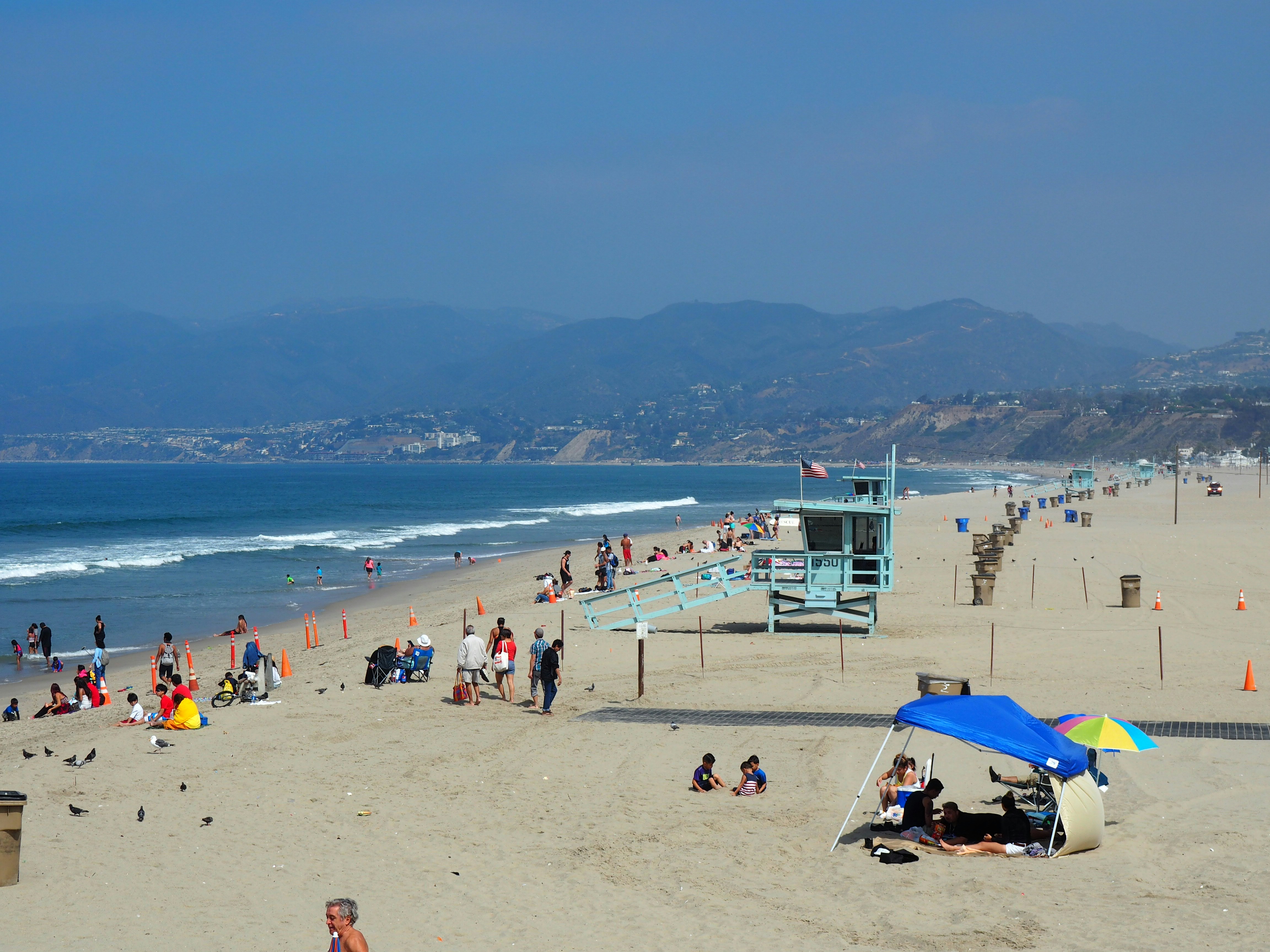 a crowded beach with many people on it