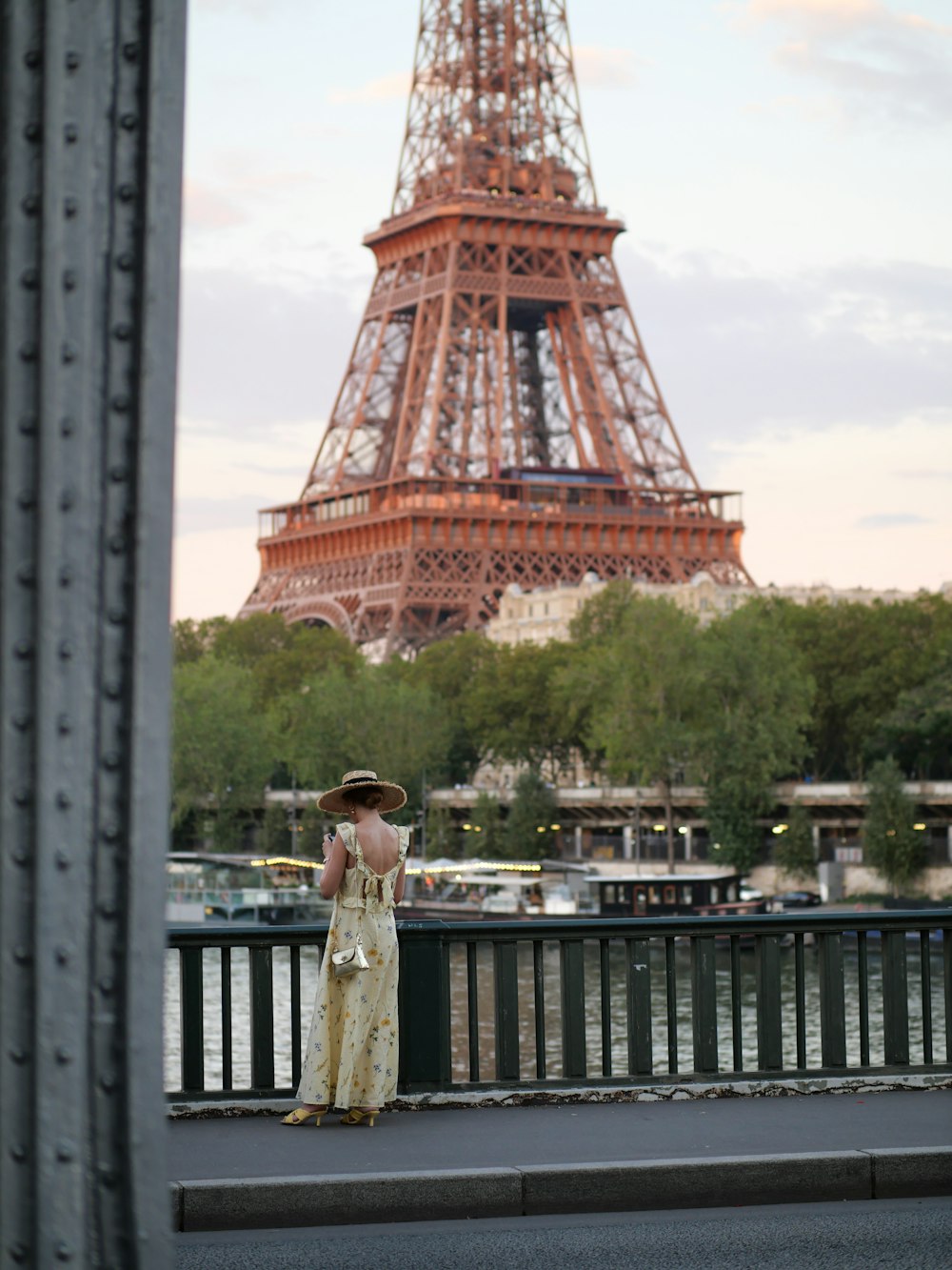 a woman standing in front of the eiffel tower