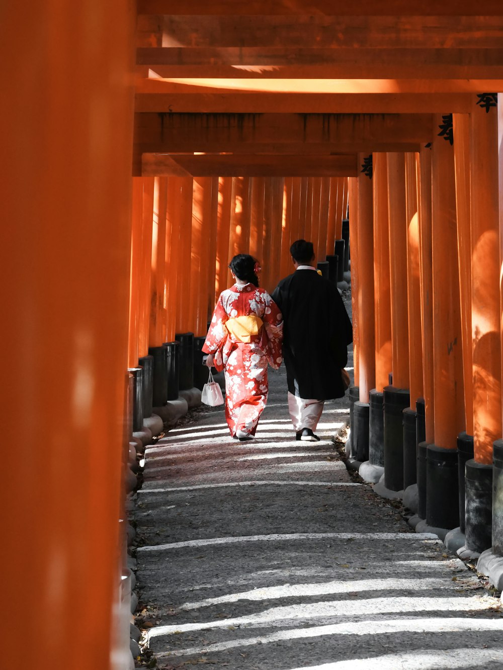 a couple of people that are walking down a path