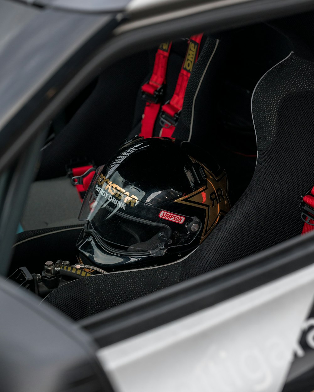 a helmet sits in the driver's seat of a car