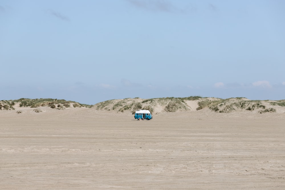 a truck is parked in the middle of the desert