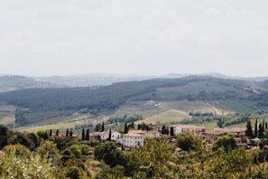 A picturesque Italian landscape featuring rolling hills and vineyards.