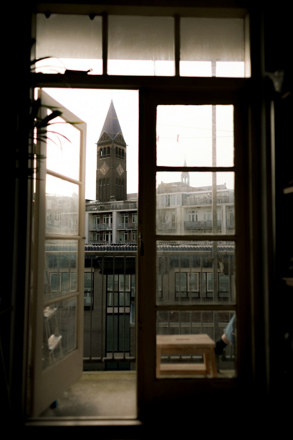 a view of a clock tower through a window