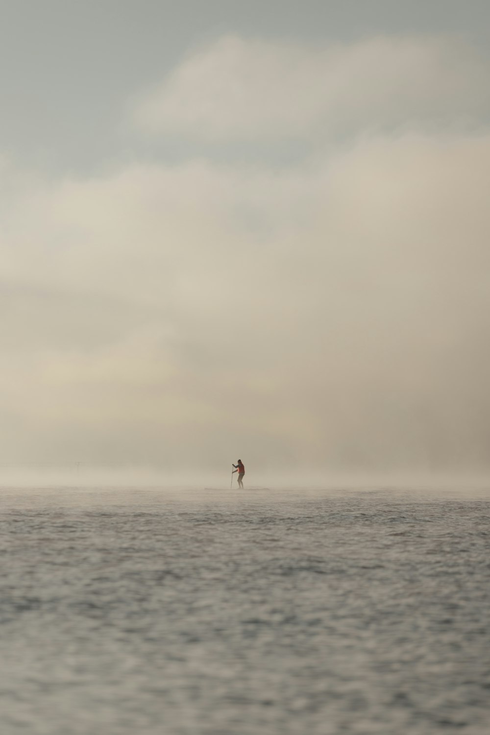 a person para sailing in the ocean on a cloudy day