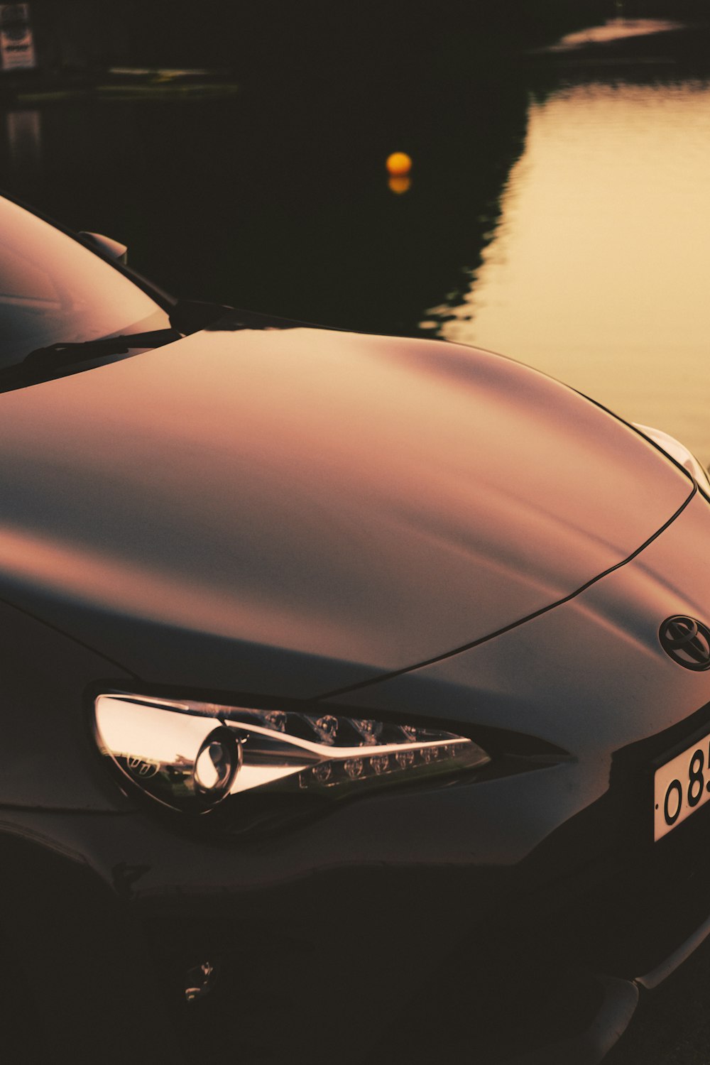 a car parked next to a body of water