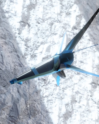 A futuristic, sleek aircraft with a blue and silver design is flying over a snowy mountainous terrain. The structure of the aircraft resembles a combination of a plane and a drone with fins and rotors. The snow on the ground contrasts with the sky and adds a dynamic visual element.