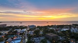 A vibrant aerial view of a bustling Florida beach town at sunset.