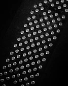 Ultra cool silver studs with a subtle shine placed on a textured fabric.