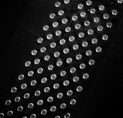 a black and white photo of a tie with lots of dots on it