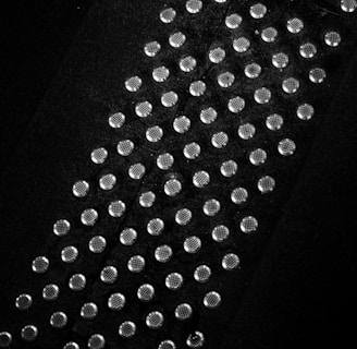 a black and white photo of a tie with lots of dots on it