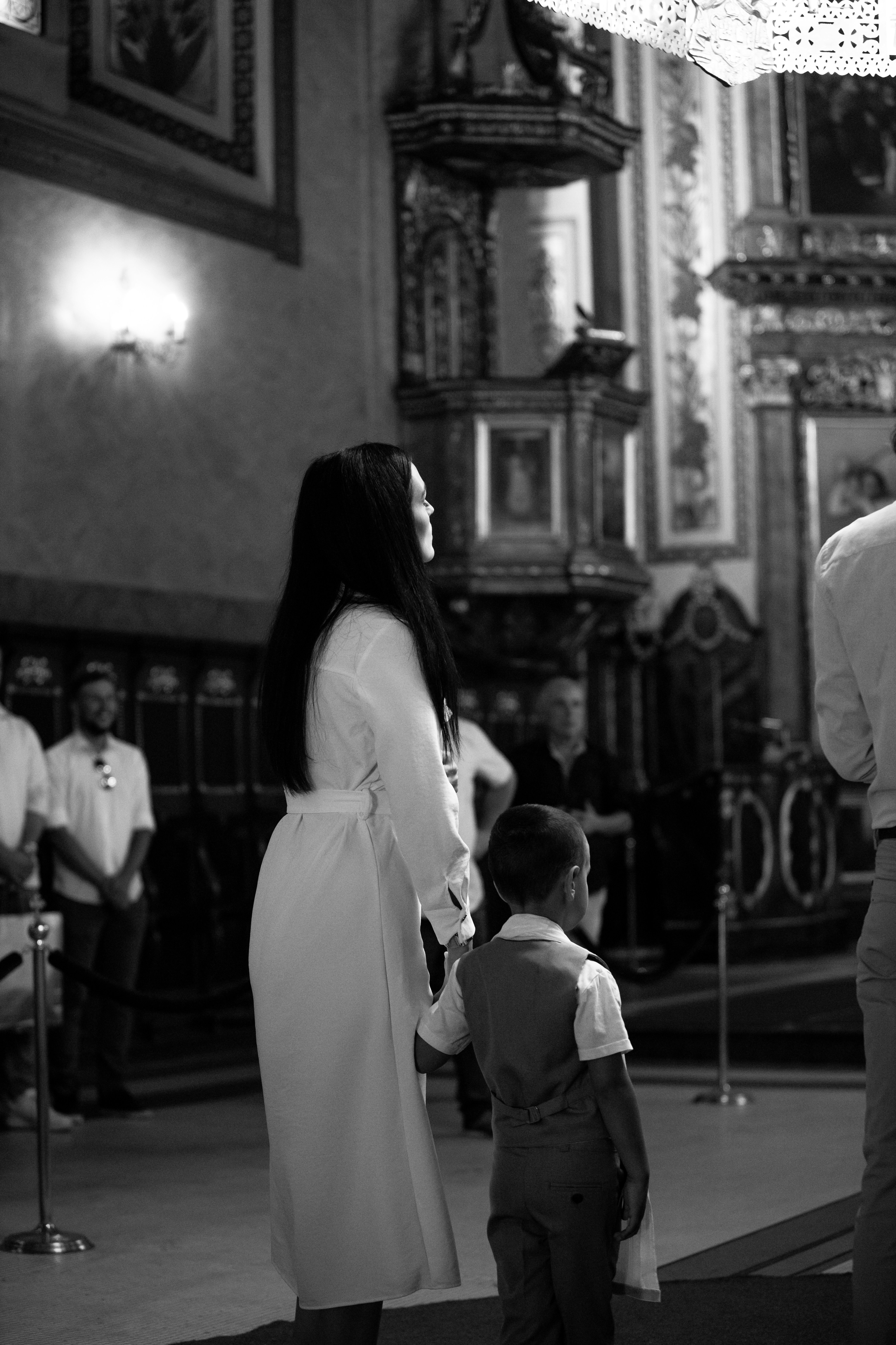 a man and a woman standing next to a little boy