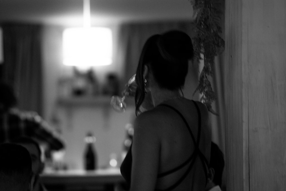 a woman standing in a kitchen next to a counter