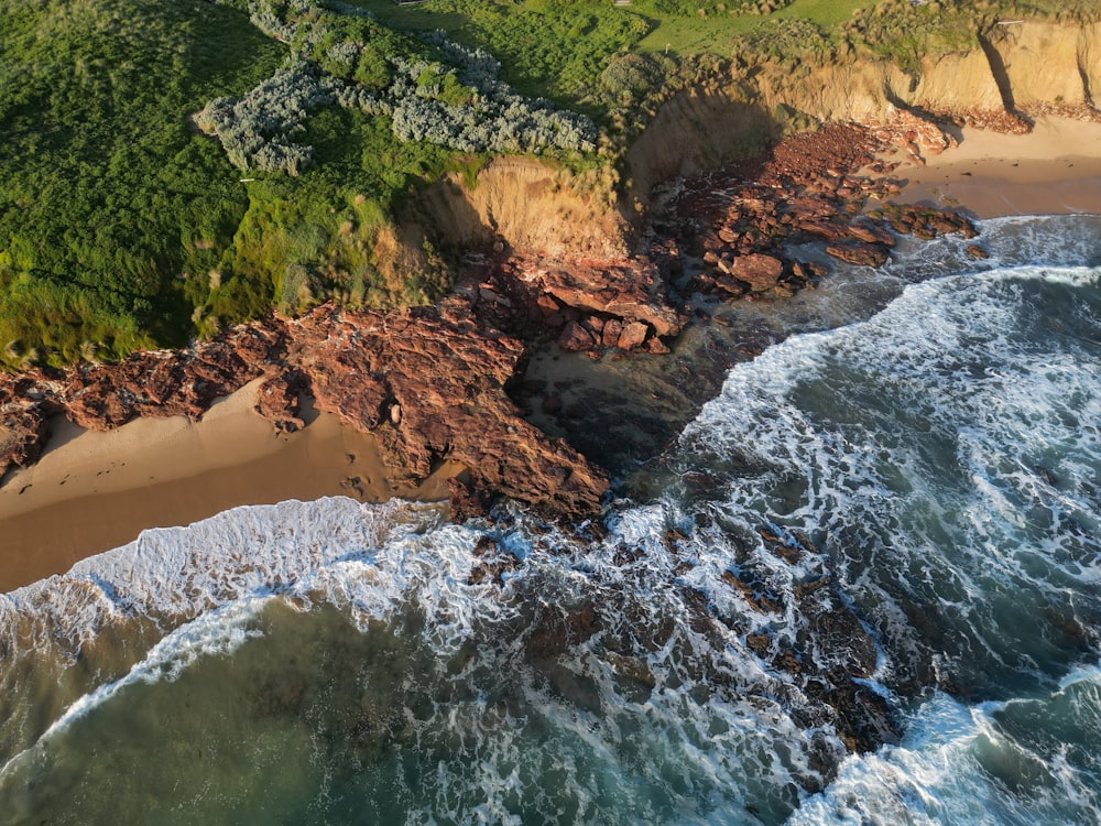 an aerial view of a beach and a cliff