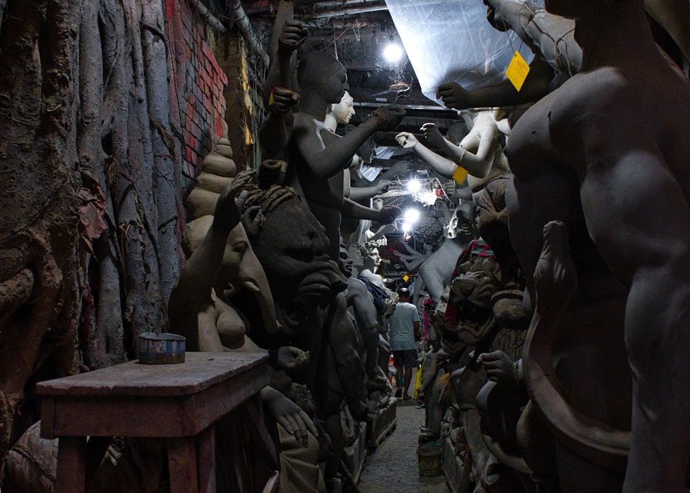 a group of mannequins are standing in a tunnel