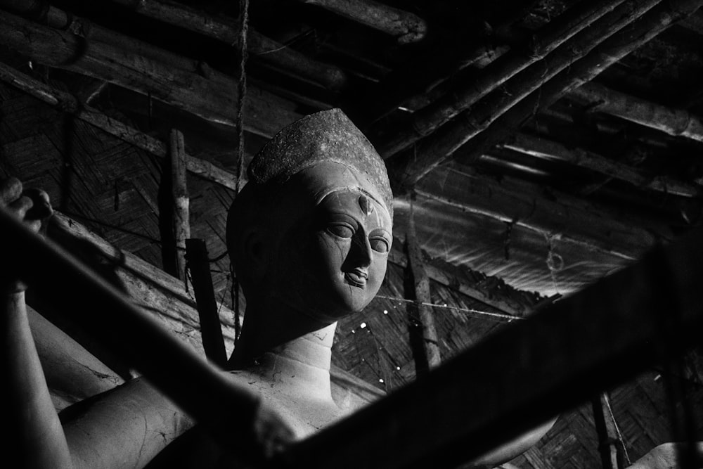 a black and white photo of a statue of a woman