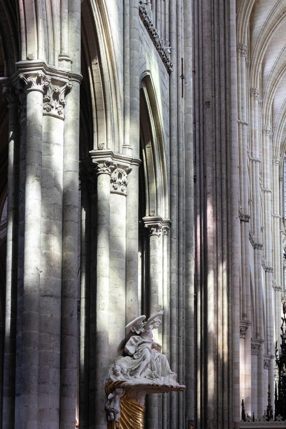 a statue is in the middle of a cathedral