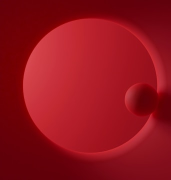 A minimalist design featuring two red spheres, one larger and one smaller, against a red backdrop. The image emphasizes smooth gradients and shadows, creating a sense of depth.