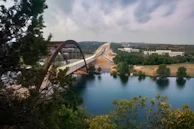 The Puente de San Martín bridge arching over the Tagus River surrounded by lush greenery.