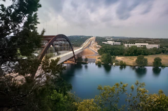 The Puente de San Martín bridge arching over the Tagus River surrounded by lush greenery.