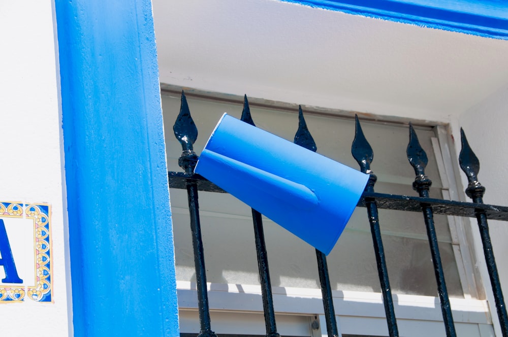 a close up of a blue sign on a fence