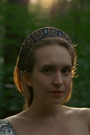 Portrait of Sarah Banda-Genchev in a forest setting, symbolizing her connection to ecosystem restoration and sustainability.