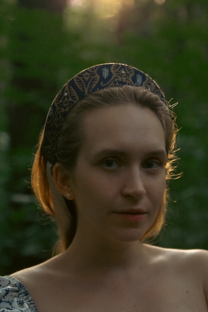 Portrait of Sarah Banda-Genchev in a forest setting, symbolizing her connection to ecosystem restoration and sustainability.