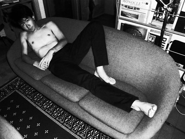 Lifestyle shot of a man comfortably lounging at home wearing breezefit hybridtrunk.