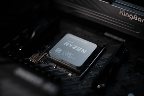 A sleek close-up of a glowing AMD Ryzen processor with neon circuitry highlights.