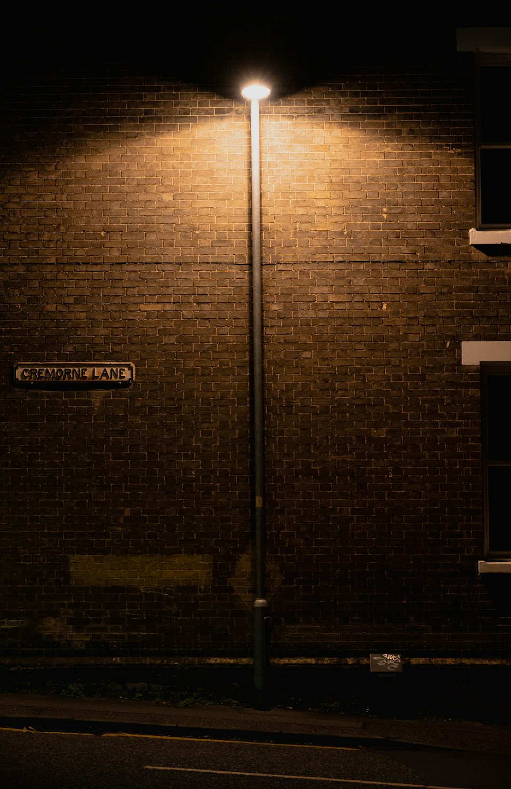 a brick building with a street light in front of it