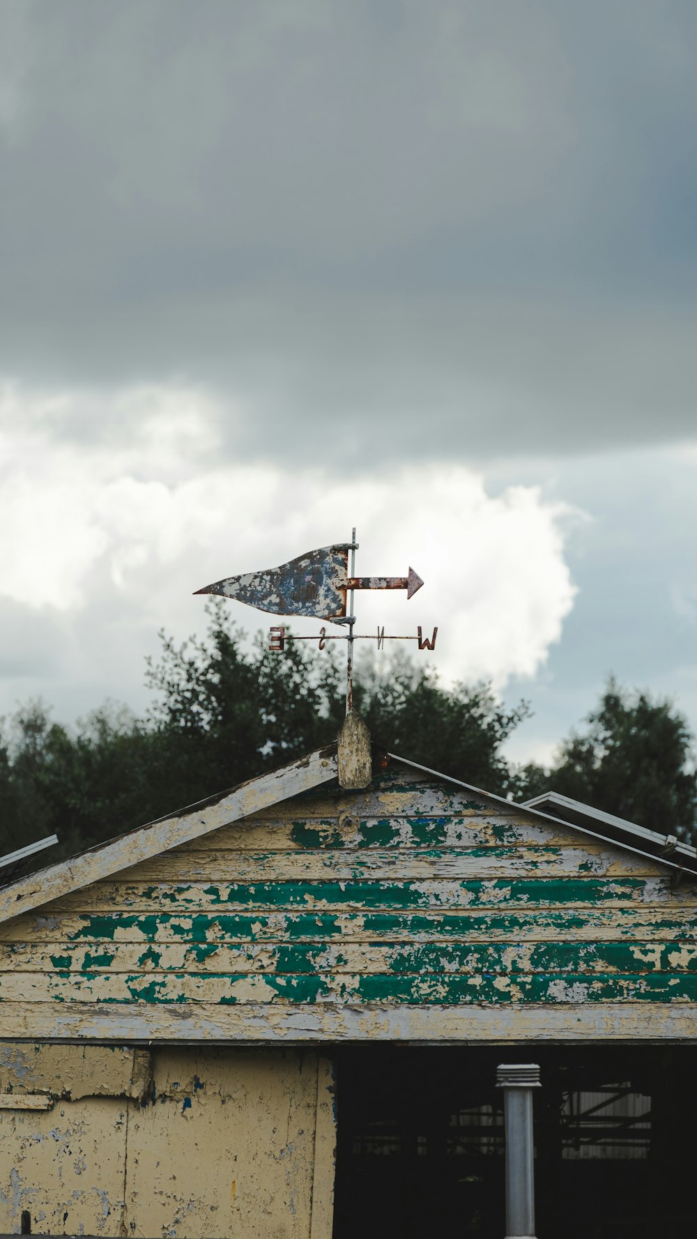 an old building with a weather vane on top of it