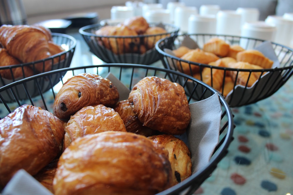 a table topped with baskets filled with pastries