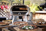 A rustic wooden pizza oven surrounded by fresh ingredients.