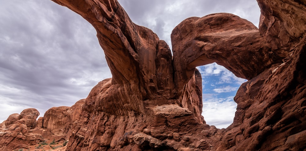 a large rock formation with a sky in the background