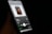 A smartphone screen displaying a music player application with an album cover. The album cover features a silhouette of a person with a hand covering part of their face. The song 'Nights' by Frank Ocean is playing, and the background is dark, highlighting the vibrant screen.