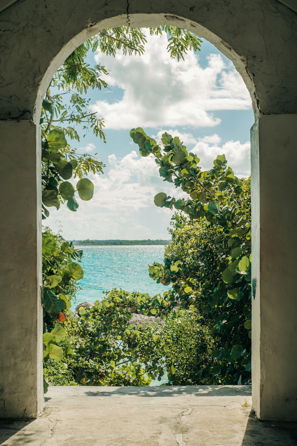 a view of a body of water through an archway