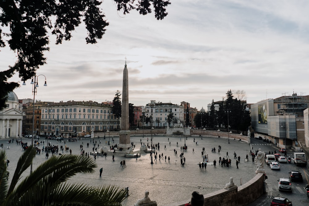 a group of people walking around a city square