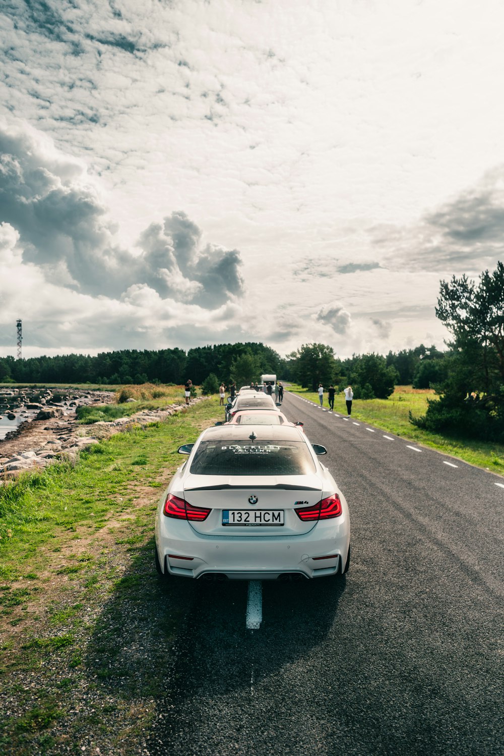 a white car parked on the side of a road