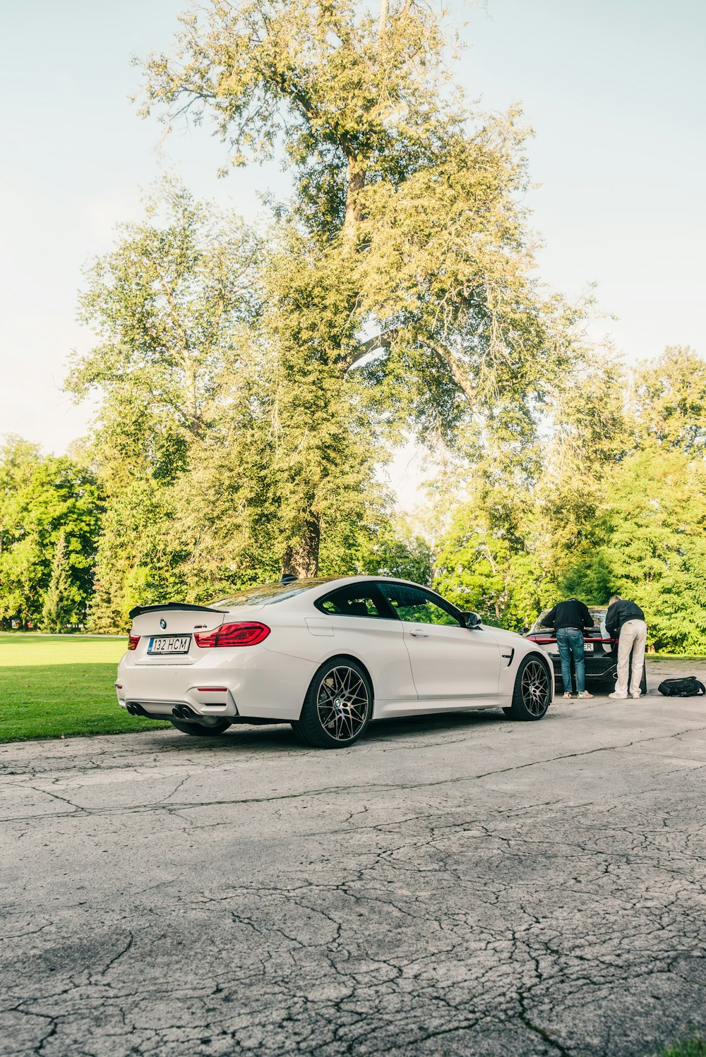 a white car parked on the side of a road