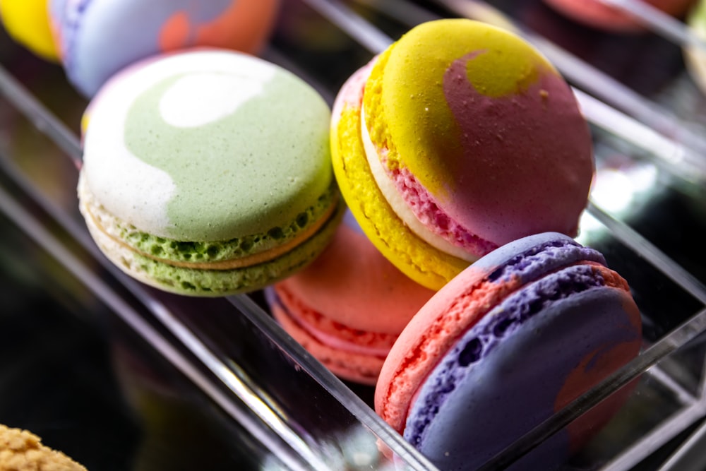 a bunch of different colored macaroons on a shelf