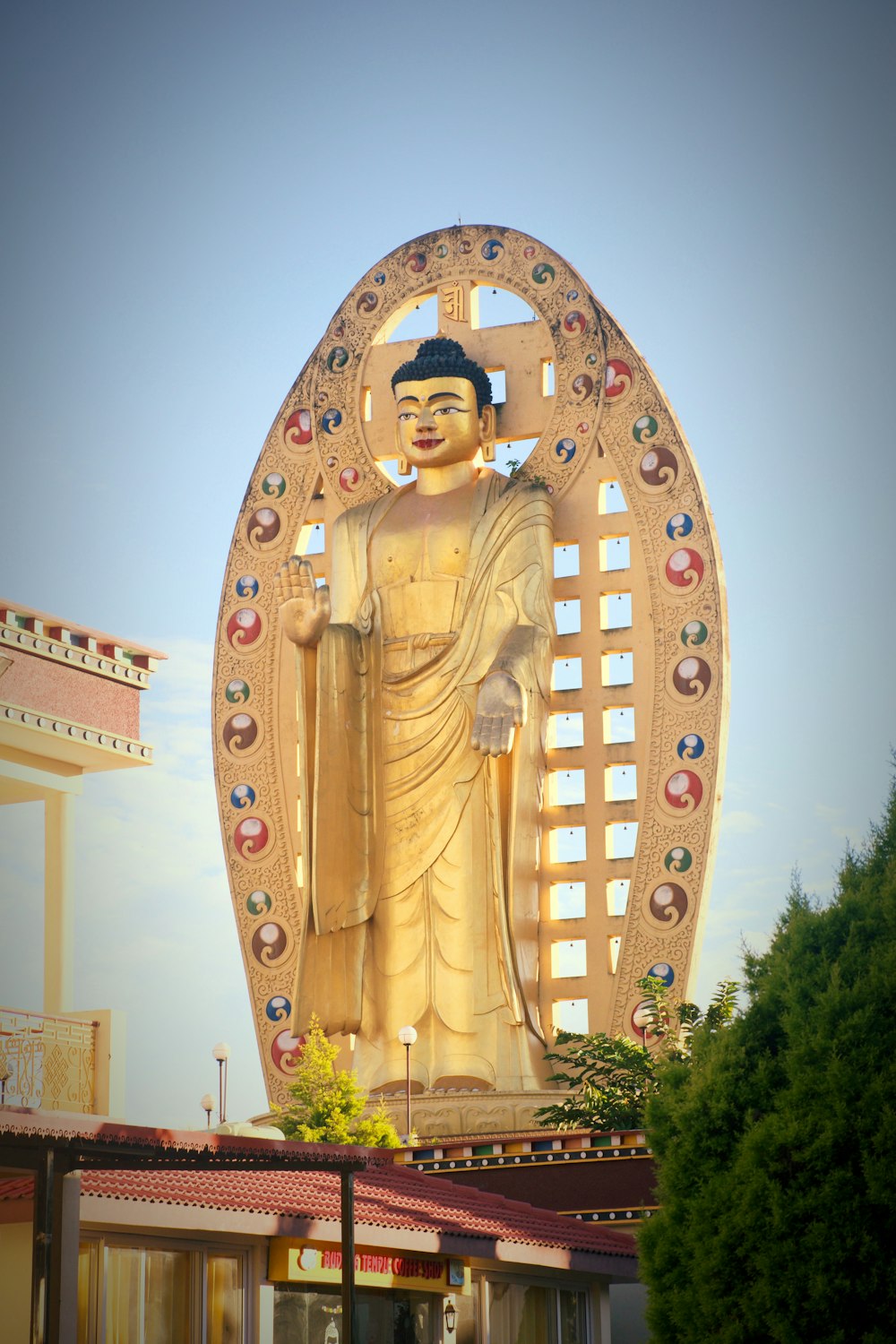 a large golden buddha statue on top of a building