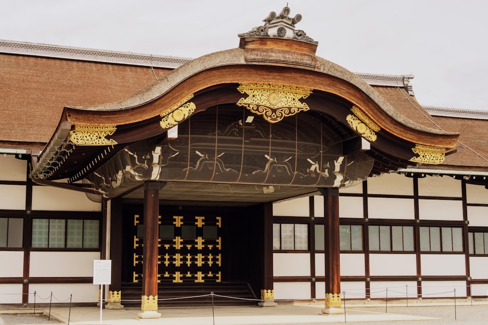 a large building with a wooden roof and gold decorations