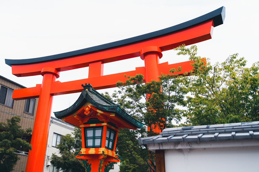 a large orange and black structure with a lantern on top of it