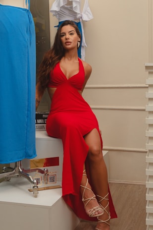 a woman in a red dress posing for a picture