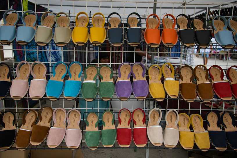 Close-up of colorful rubber sandals arranged on a wooden surface.